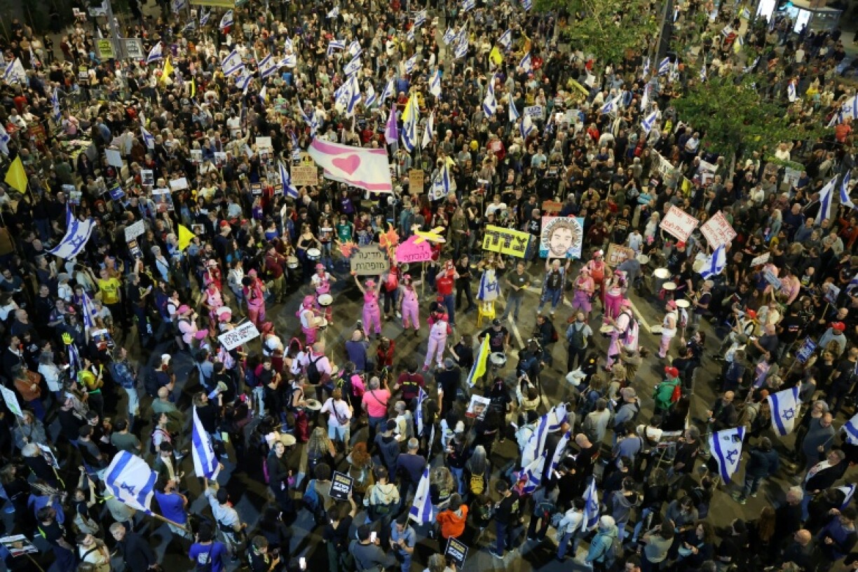Israelis demonstrate outside the defence ministry in Tel Aviv on Saturday demanding action by the government to bring home the remaining hostages.