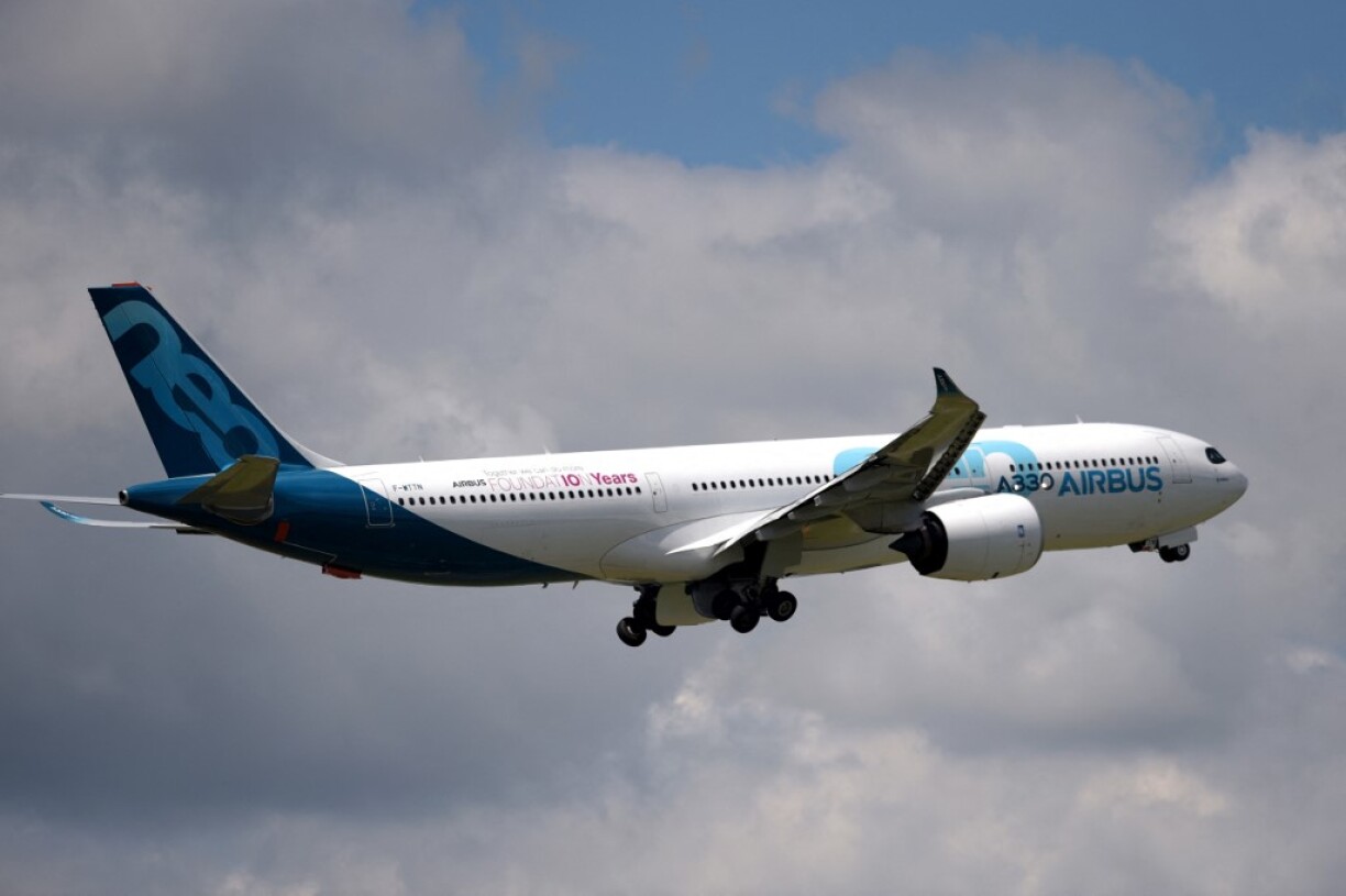 An Airbus A320 Neo flying over Paris–Le Bourget Airport.