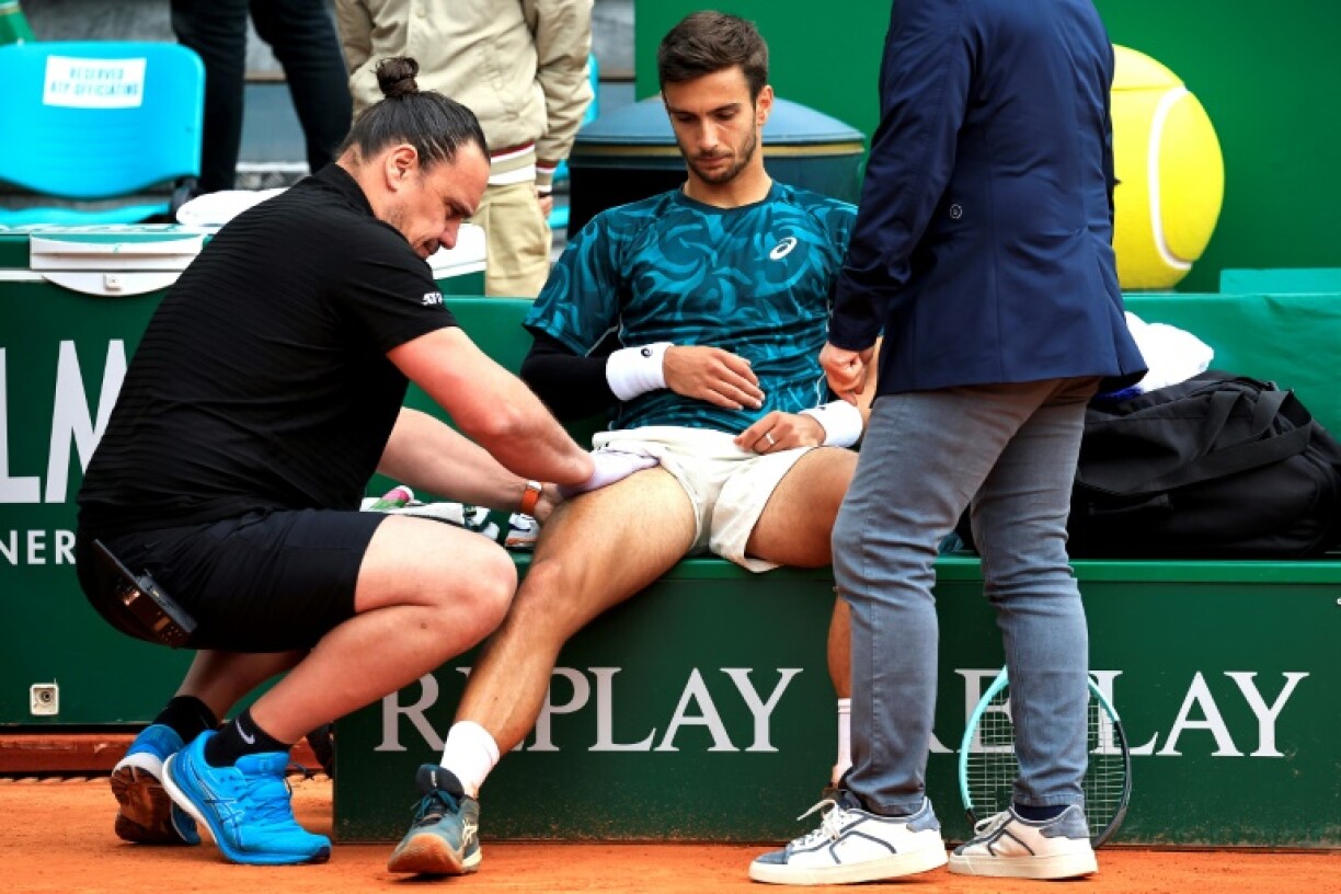 Lorenzo Musetti (C) needed medical treatment in the third set as he lost to Carlos Alcaraz in the final of the Monte Carlo Masters