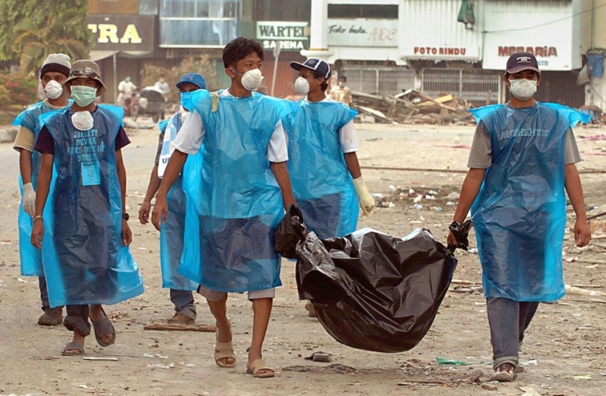 Indonesian civilians on December 31, 2004 carry a dead body six days after a huge wave and powerful earthquake hit Banda Aceh