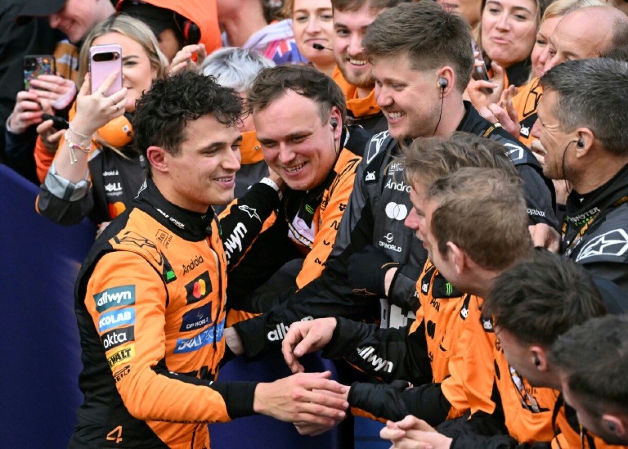 Lando Norris (left) celebrates with his McLaren team after winning the Australian Grand Prix