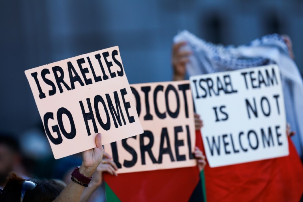 Pro-Palestinian protestors in Madrid hold up banners before invading the street and forcing race organisers to abandon the last stage of the Vuelta a Espana