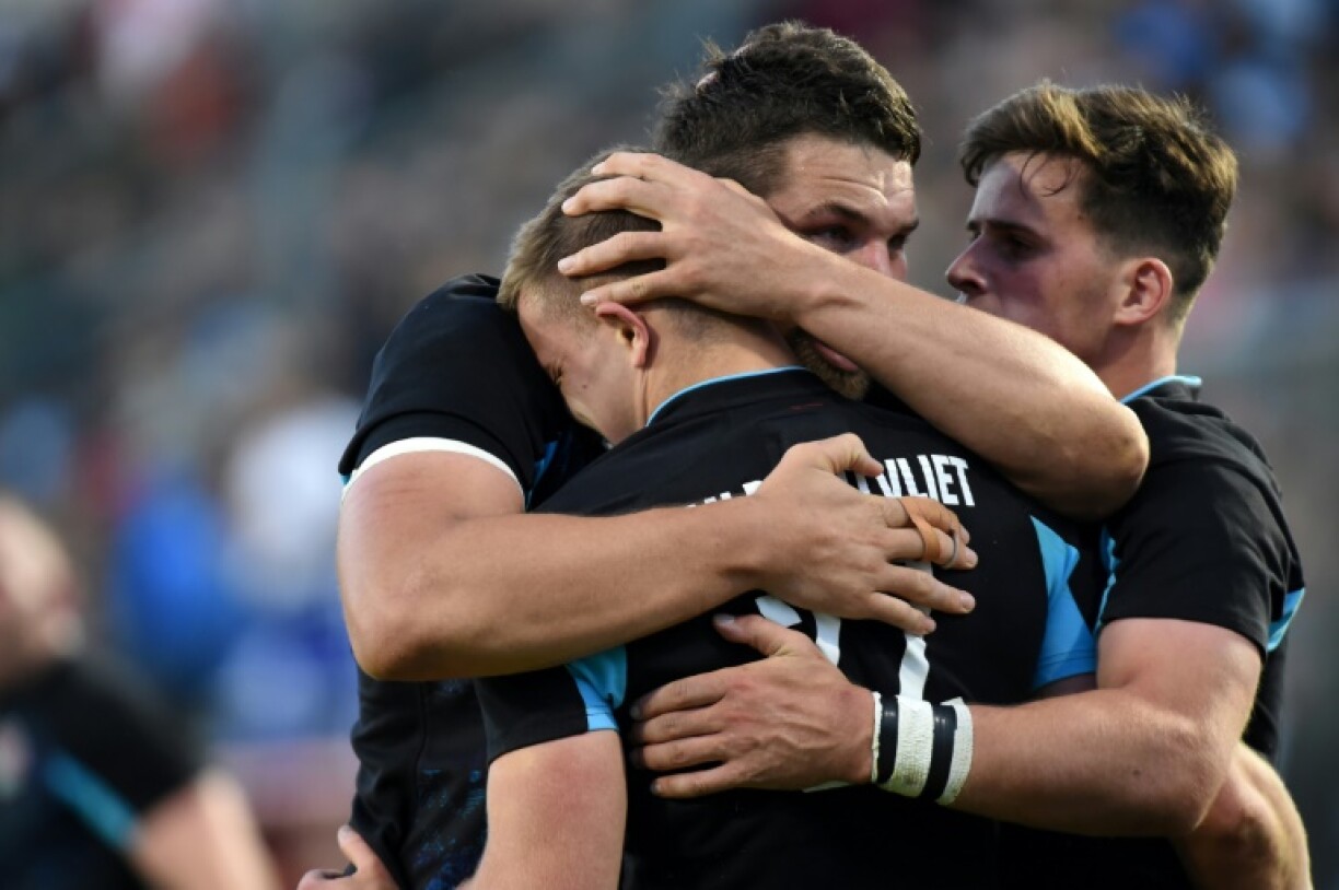 England's scrum-half Jack van Poortvliet, at front hugged by teammates, was among the try scorers for the Lions in a 40-5 rugby union victory over the United States at Washington