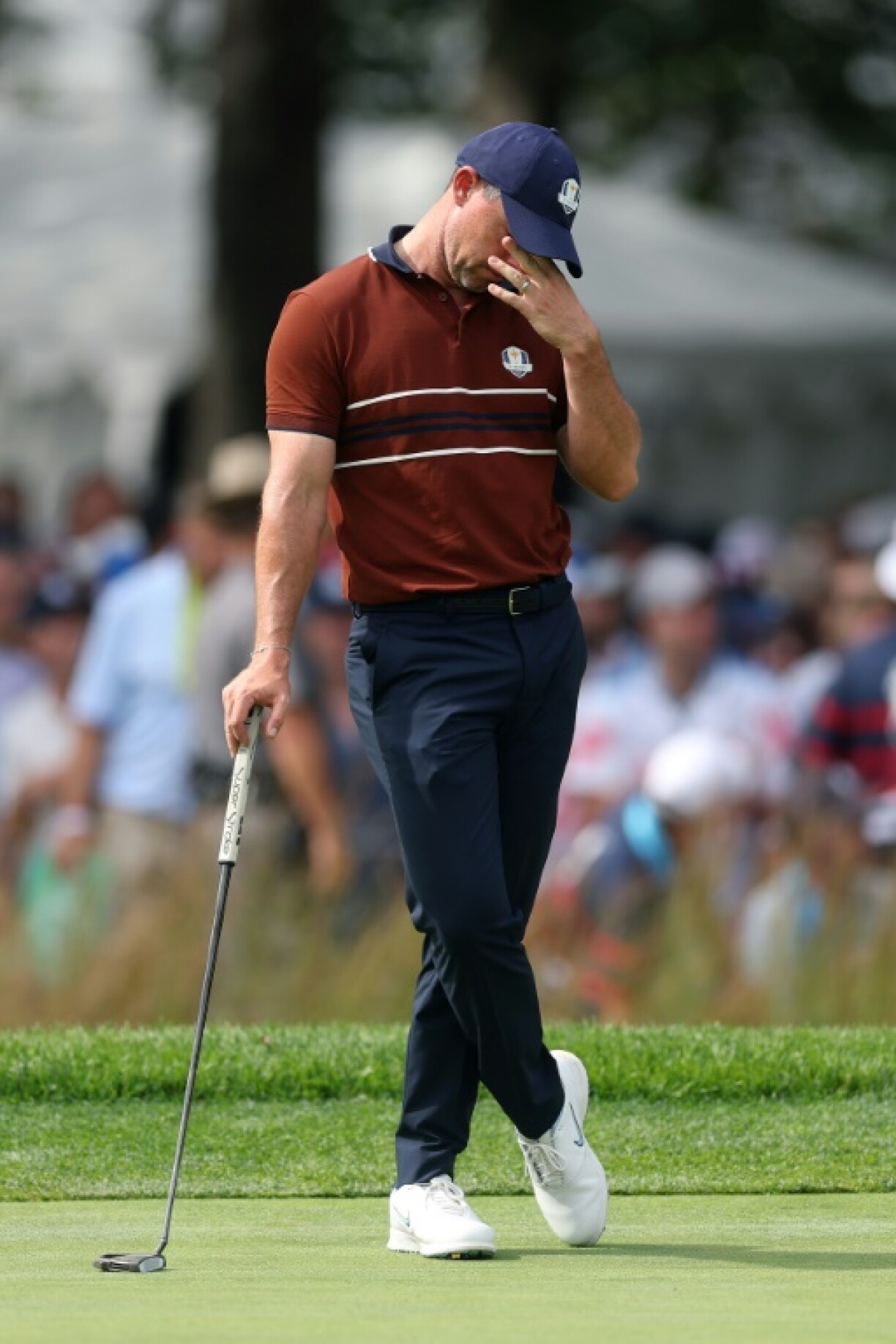 Rory McIlroy, a tremendous target for hecklers, hangs down his head on the seventh green in a four-balls match at the 45th Ryder Cup