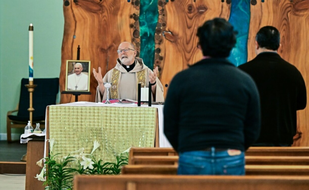 A portrait of the late pope Francis rests on the altar during a mass at St Camillus Catholic Church in Los Angeles, California, following the selection of American Robert Francis Prevost to be the new pontiff, Pope Leo XIV