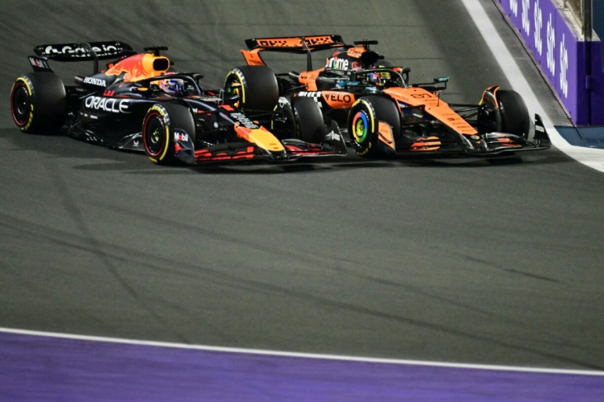 Red Bull's Max Verstappen (L) was given a 5-second penalty for leaving the track and gaining an advantage over McLaren's Oscar Piastri (R)