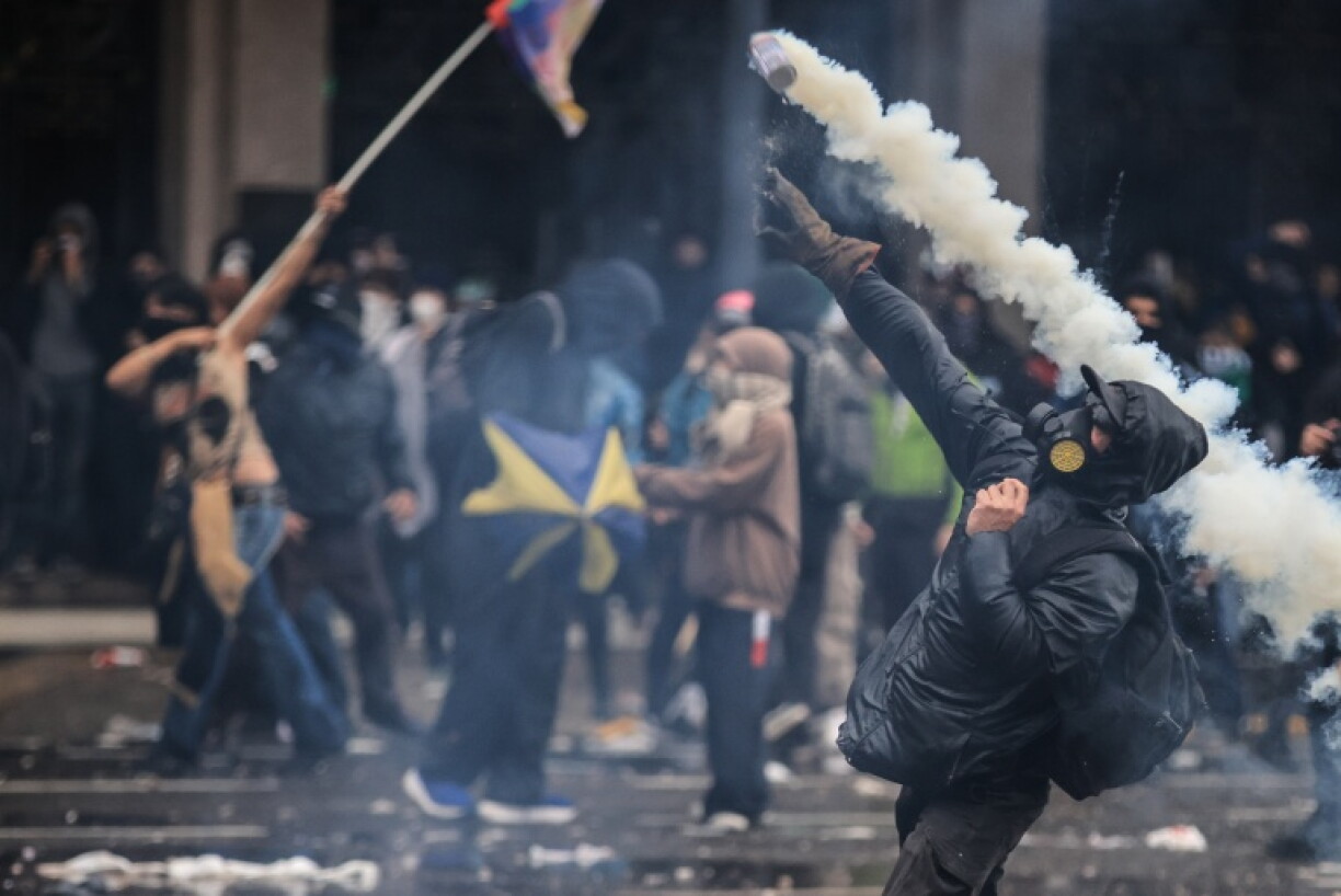 A man throws tear gas during a demonstration in Buenos Aires against budget-slashing Argentine President Javier Milei's education spending