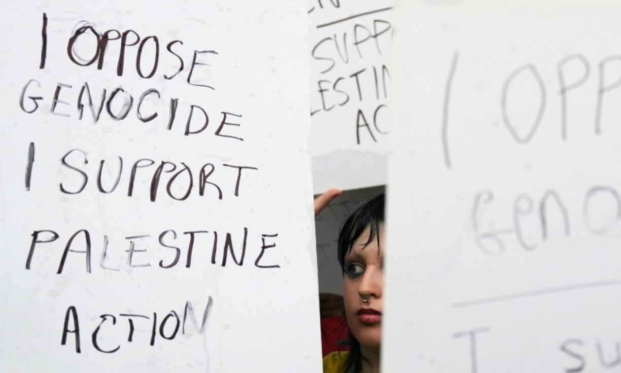 UK protesters hold up signs reading 'I oppose genocide, I support Palestine Action'