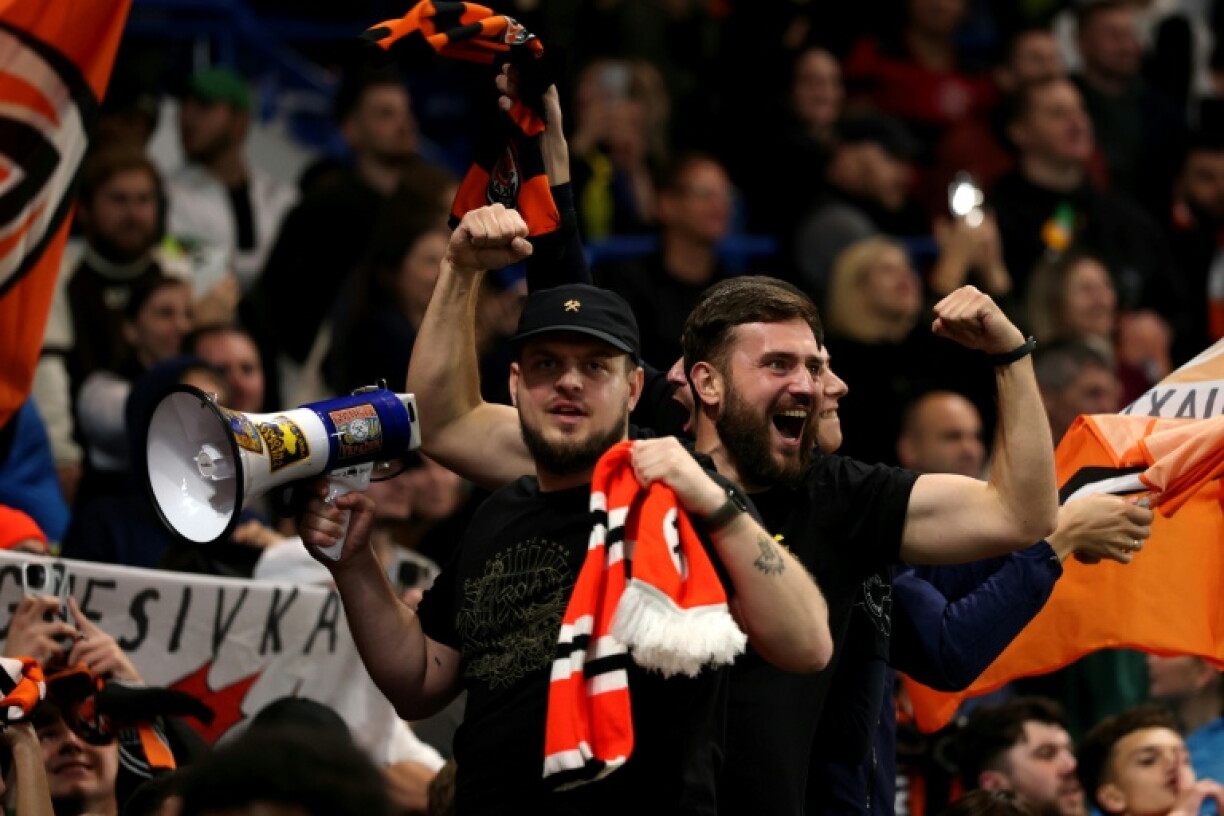 Shakhtar Donetsk fans celebrate their team's second goal against AEK Athens at Stamford Bridge