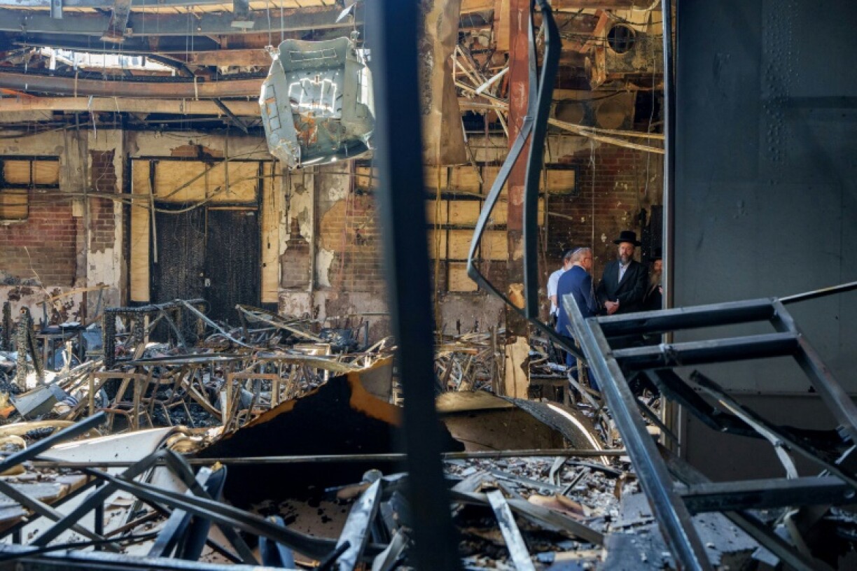 Australia's Prime Minister Anthony Albanese (2nd R) and Rabbi Shlomo Kohn (R) visit the Adass Israel Synagogue in Melbourne on December 10, 2024, after it was set ablaze