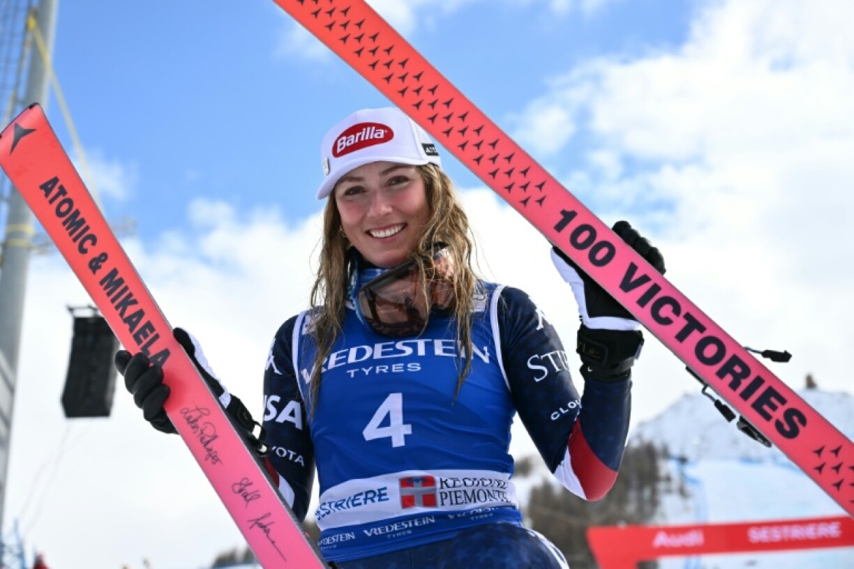 Mikaela Shiffrin poses with skis marking her