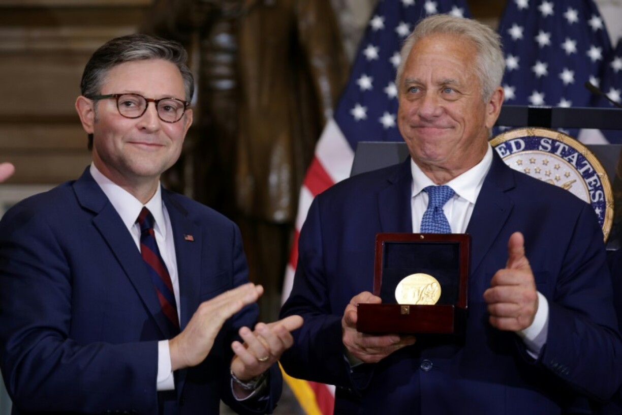 Speaker of the House US Representative Mike Johnson presents the Congressional Gold Medal to American cycling great Greg LeMond