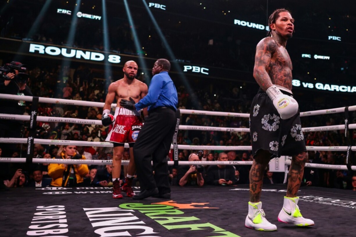 Gervonta Davis (d.) se dirige vers son coin à la fin du 8e round lors de son combat contre Hector Luis Garcia (g.) pour le titre de champion du monde WBA des poids légers à Washington, le 7 janvier 2023