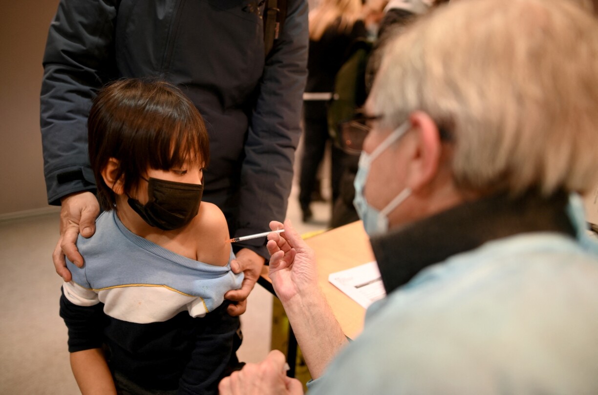 A child receives a Pfizer Covid-19 vaccine in Paris, France on 23 December 2021.