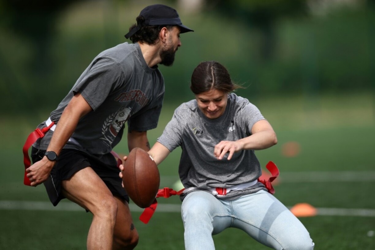 Elisa De Santis, the captain of the women's French flag football team, takes on an opponent in a demonstration