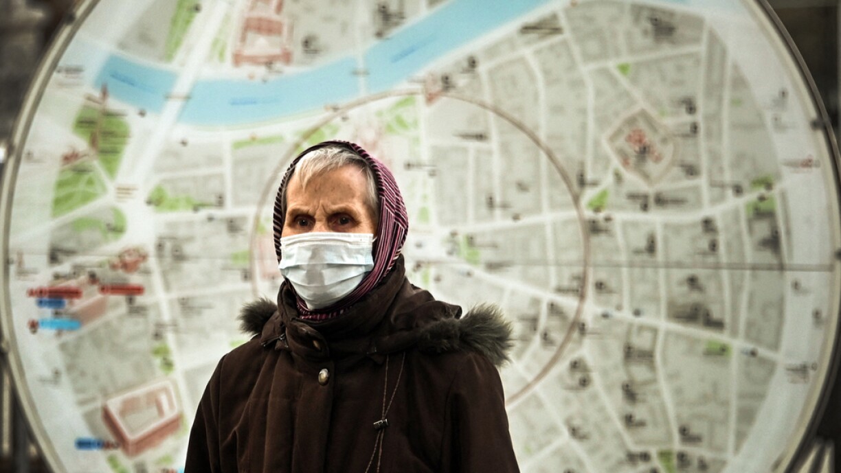A woman wearing a protective mask walks past a street map in central Moscow, on October 18, 2021, amid the outbreak of Covid-19, caused by the novel coronavirus. Russia on Sunday reported a new record for coronavirus infections for a fourth day in a row, a day after the worst-affected country in Europe set a new death toll high. There were 34,303 new infections and 997 deaths registered in the country over 24 hours, according to the official toll.