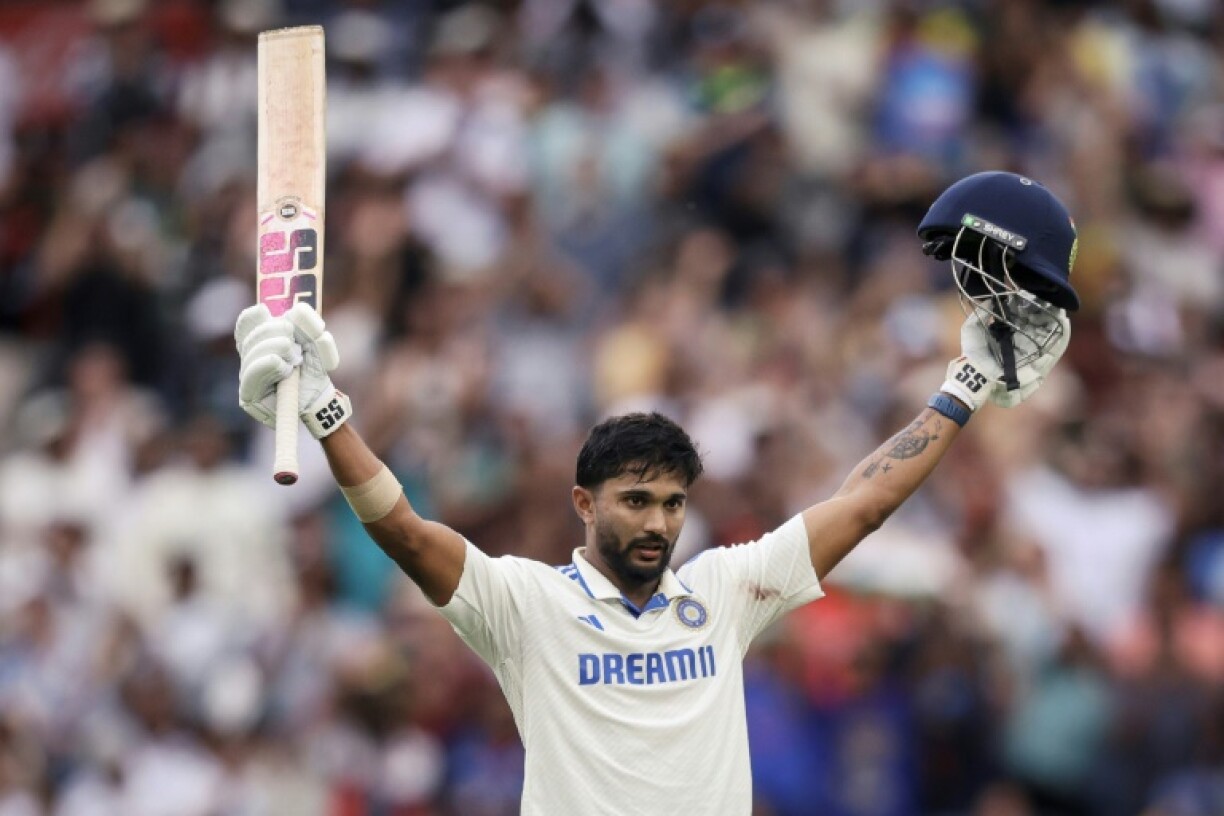 India's Nitish Kumar Reddy celebrates after reaching his maiden Test 100 on day three against Australia in Melbourne