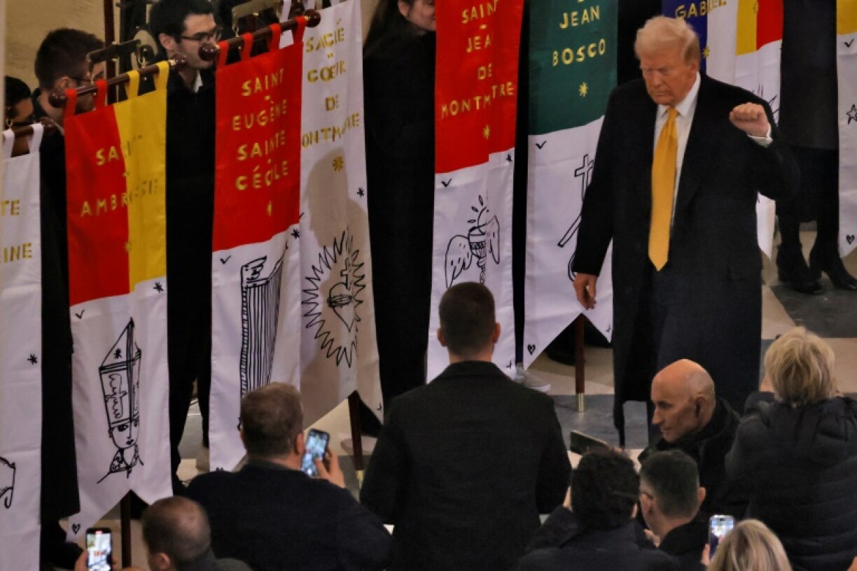 Trump gestures with a raised fist as he entered the cathedral