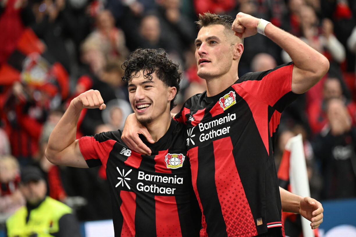 Bayer Leverkusen's Czech forward #14 Patrik Schick celebrates scoring his team's second goal with Bayer Leverkusen's Algerian midfielder #30 Ibrahim Maza during the German first division Bundesliga football match between Bayer Leverkusen and SC Freiburg in Leverkusen, western Germany, on October 18, 2026. (Photo by INA FASSBENDER / AFP) / DFL REGULATIONS PROHIBIT ANY USE OF PHOTOGRAPHS AS IMAGE SEQUENCES AND/OR QUASI-VIDEO