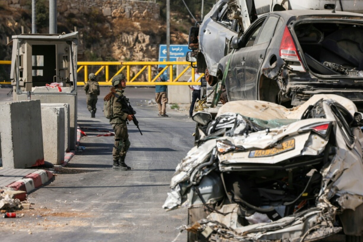 An Israeli soldier speaks with a driver at the blocked northern checkpoint in Hebron in the occupied West Bank
