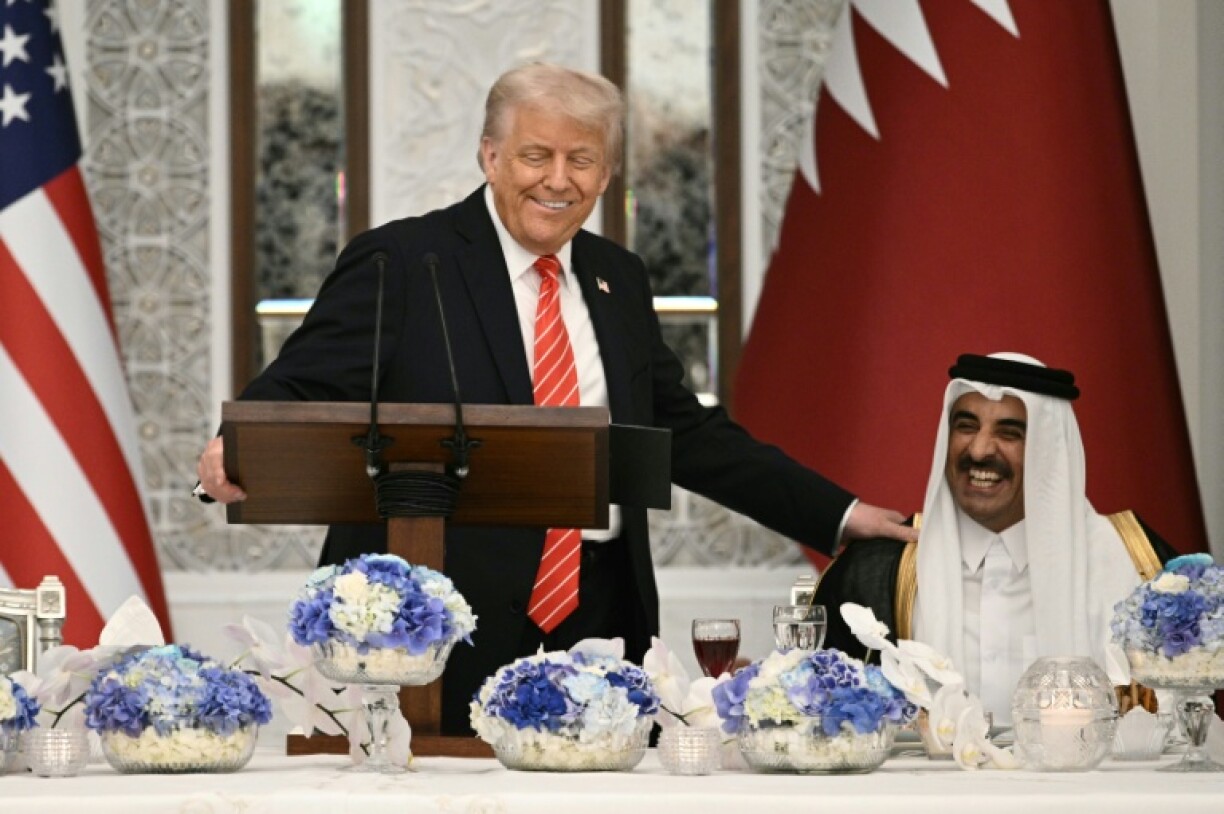 US President Donald Trump shares a laugh with Qatar's emir, Sheikh Tamim bin Hamad al-Thani, at the start of a state dinner at the Lusail Palace in Doha.