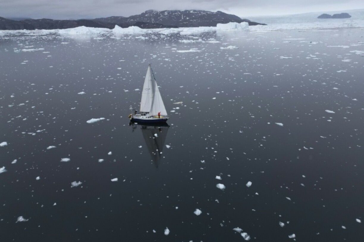 Brazilian sailor Tamara Klink poses on her sailboat 'Sardinha 2' as she completed her trip through the Northwest Passage