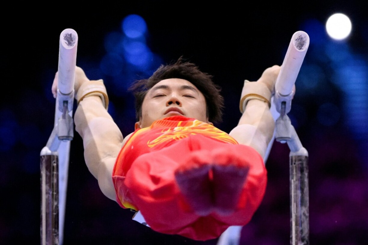 China's Jingyuan Zou swinging to the men's parallel bars world title