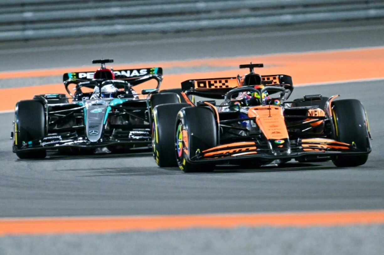McLaren's Australian driver Oscar Piastri (R) drives ahead of Mercedes' British driver George Russell during the sprint race ahead of the Qatari Formula One Grand Prix in Doha
