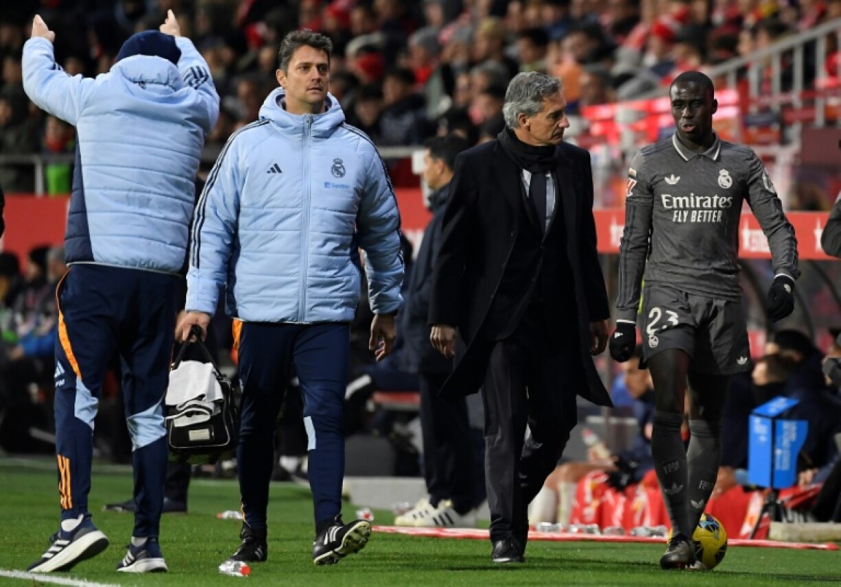 Real Madrid's French defender Ferland Mendy (R) leaves the pitch after an injury against Girona