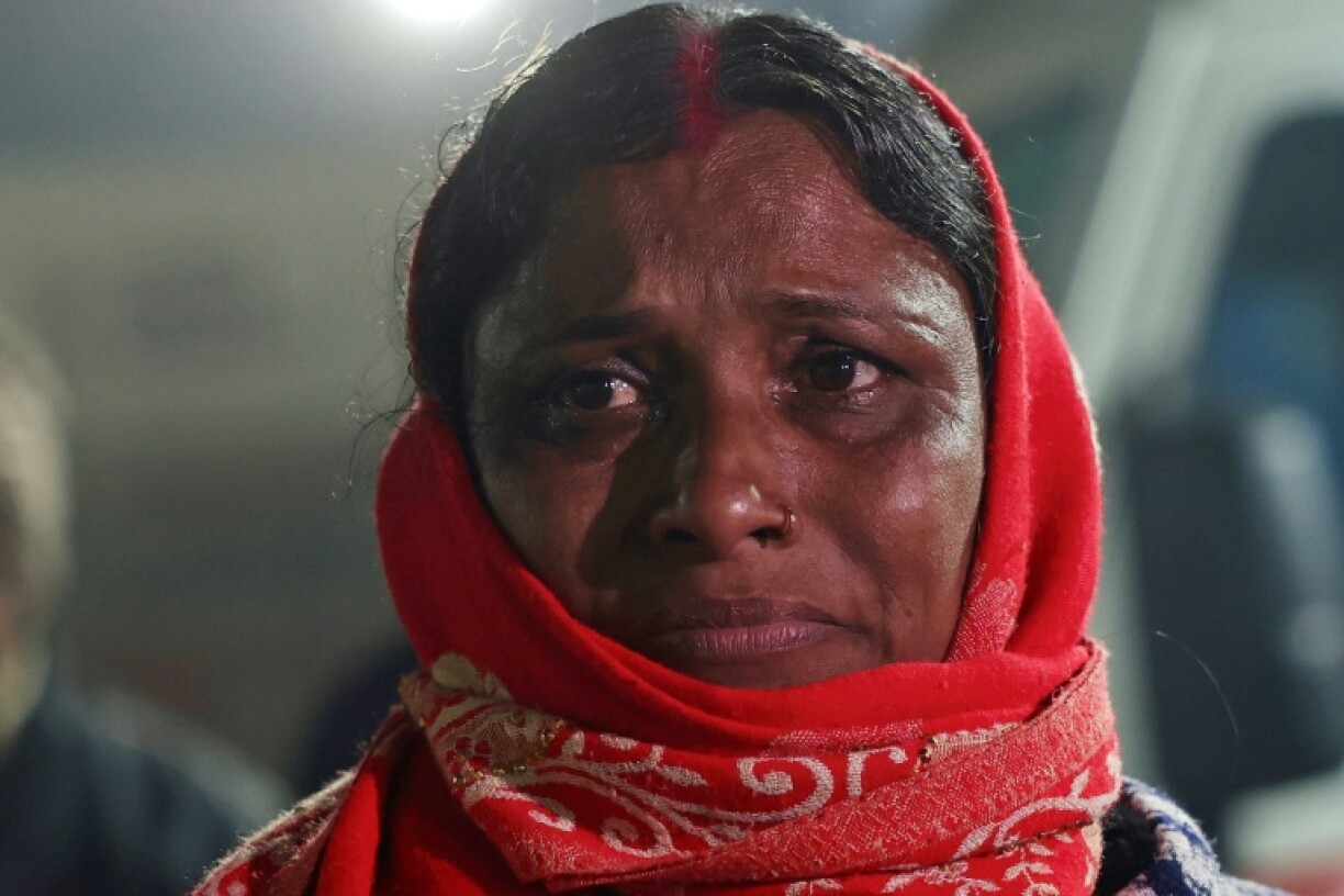 A pilgrim weeps outside a hospital after a deadly stampede during the Kumbh Mela festival in Prayagraj, India