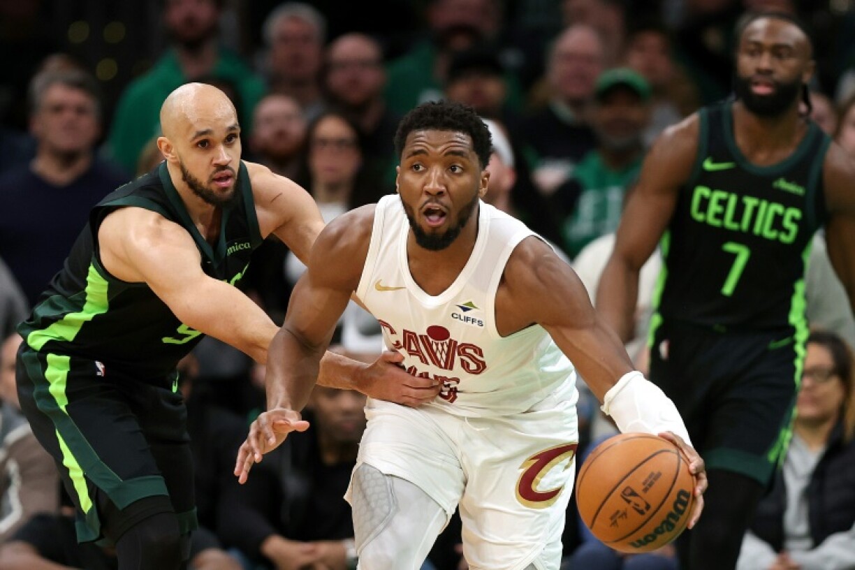 Donovan Mitchell of the Cleveland Cavaliers drives past Derrick White in the Cavs' NBA victory over the Boston Celtics