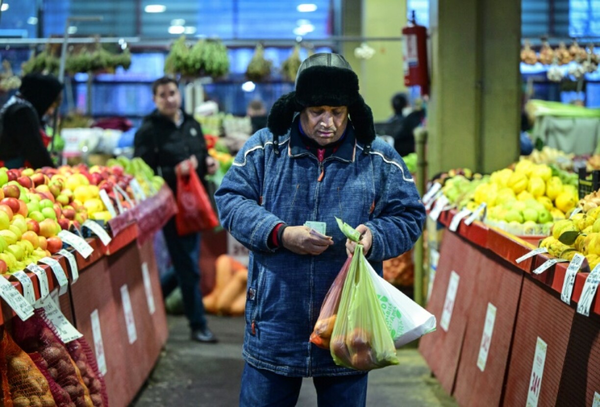 A customer counts his money at Piata Obor market