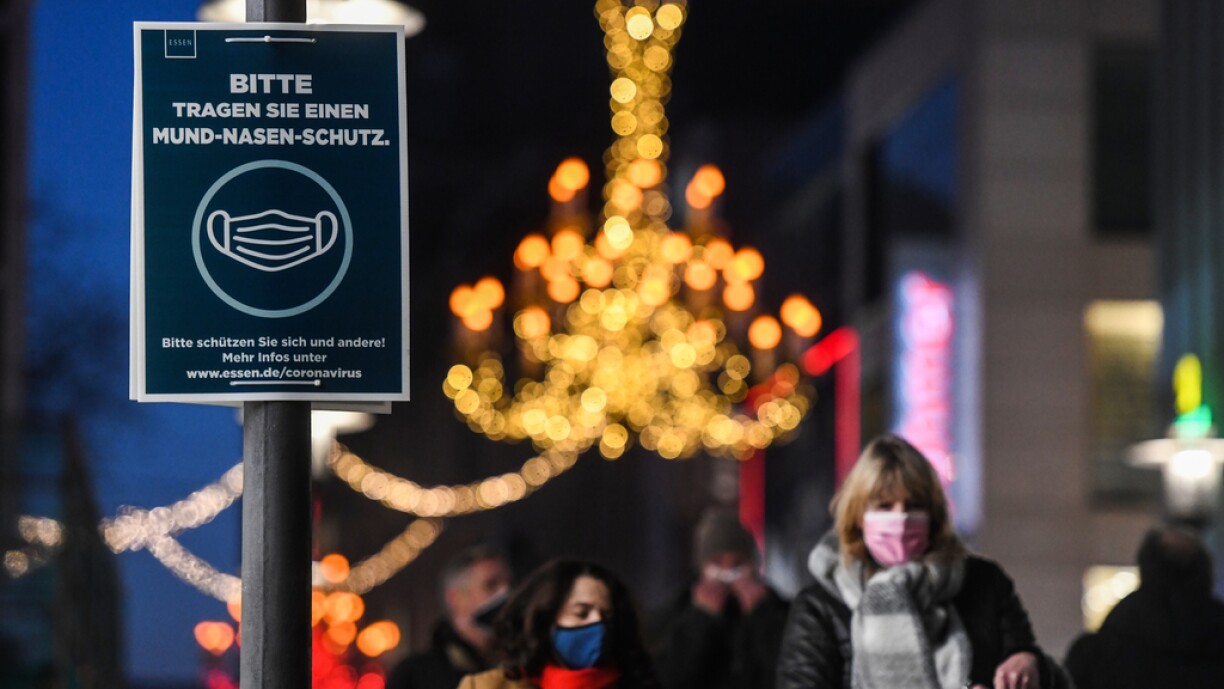 This picture taken on December 9, 2020 shows a sign to wear a face mask and reading 'please wear a face mask' at the pedestrian zone in Essen, western Germany.
