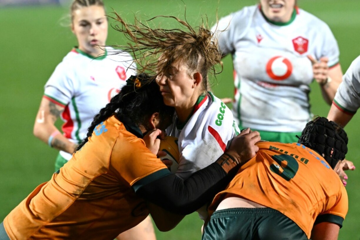 Taking guard: Australia’s Faliki Pohiva (L) and Samantha Wood tackle Carys Cox (C) of Wales in a Test in Sydney on August 1. At the World Cup, the players will wear high-tech gum shields