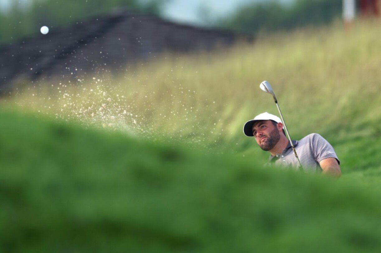 Top-ranked Scottie Scheffler of the United States plays a shot from the bunker on the 17th hole at Oakmont during the first round of the 125th US Open