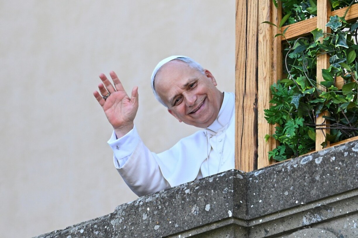 Pope Leo XIV waves to people from the terrace of the summer papal estate in Castel Gandolfo