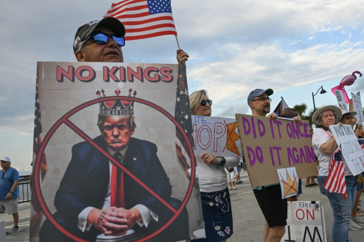 Protesters hold signs and flags during the 'No Kings' national day of protest in May
