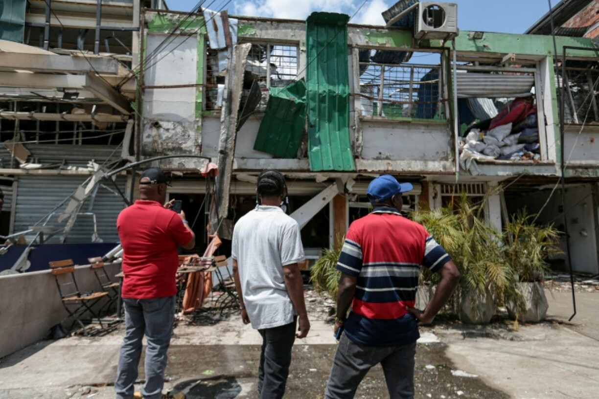 People look at a damaged building at the site of a bomb explosion the previous day in Cali, Colombia