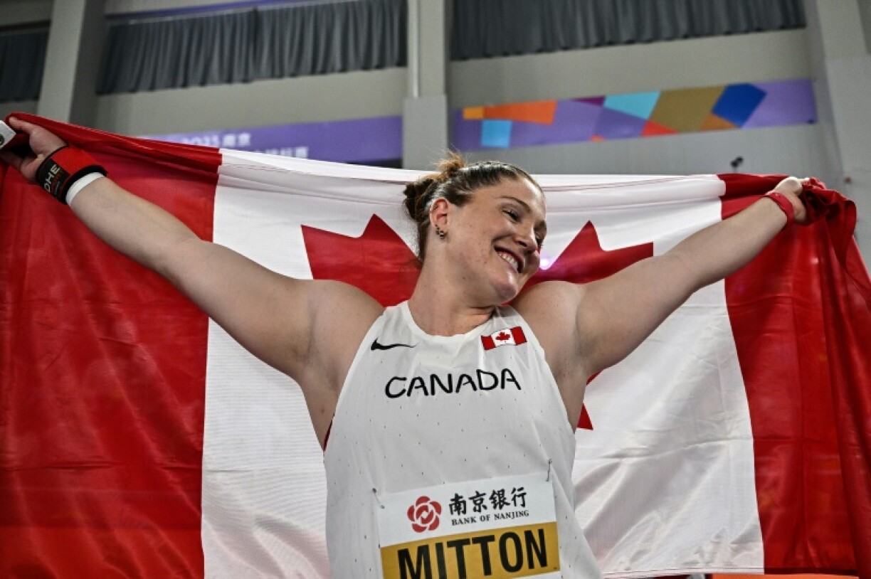 Canada's Sarah Mitton celebrates her shot put gold