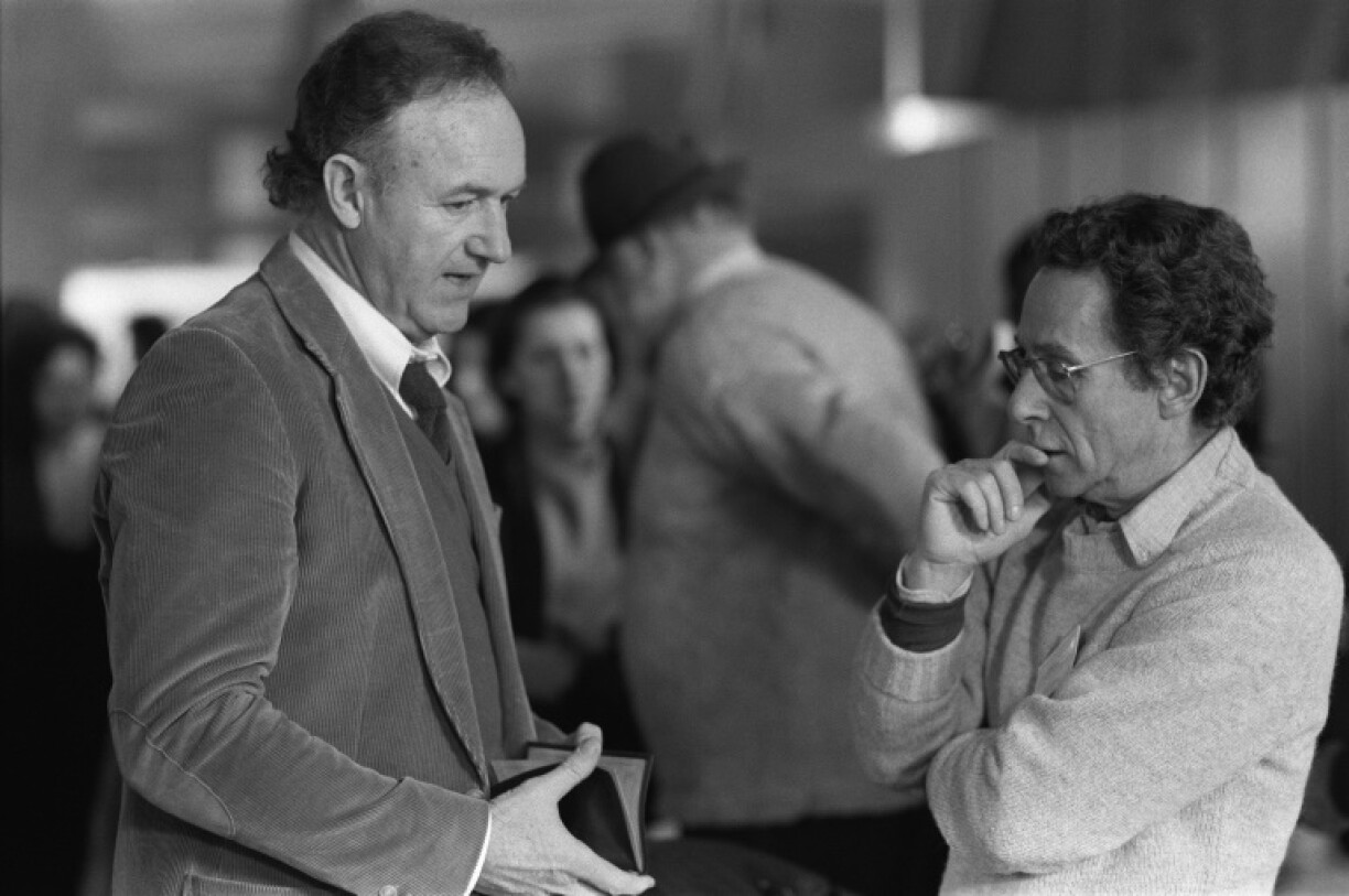 US film director Arthur Penn (R) listens to Gene Hackman during the filming of