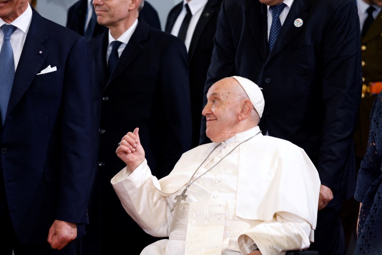 Pope Francis (R) is accompanied by officials during a farewell ceremony following a visit to Luxembourg, at Luxembourg Findel Airport on September 26, 2024. The pope is on a four-day apostolic journey to Luxembourg and Belgium.