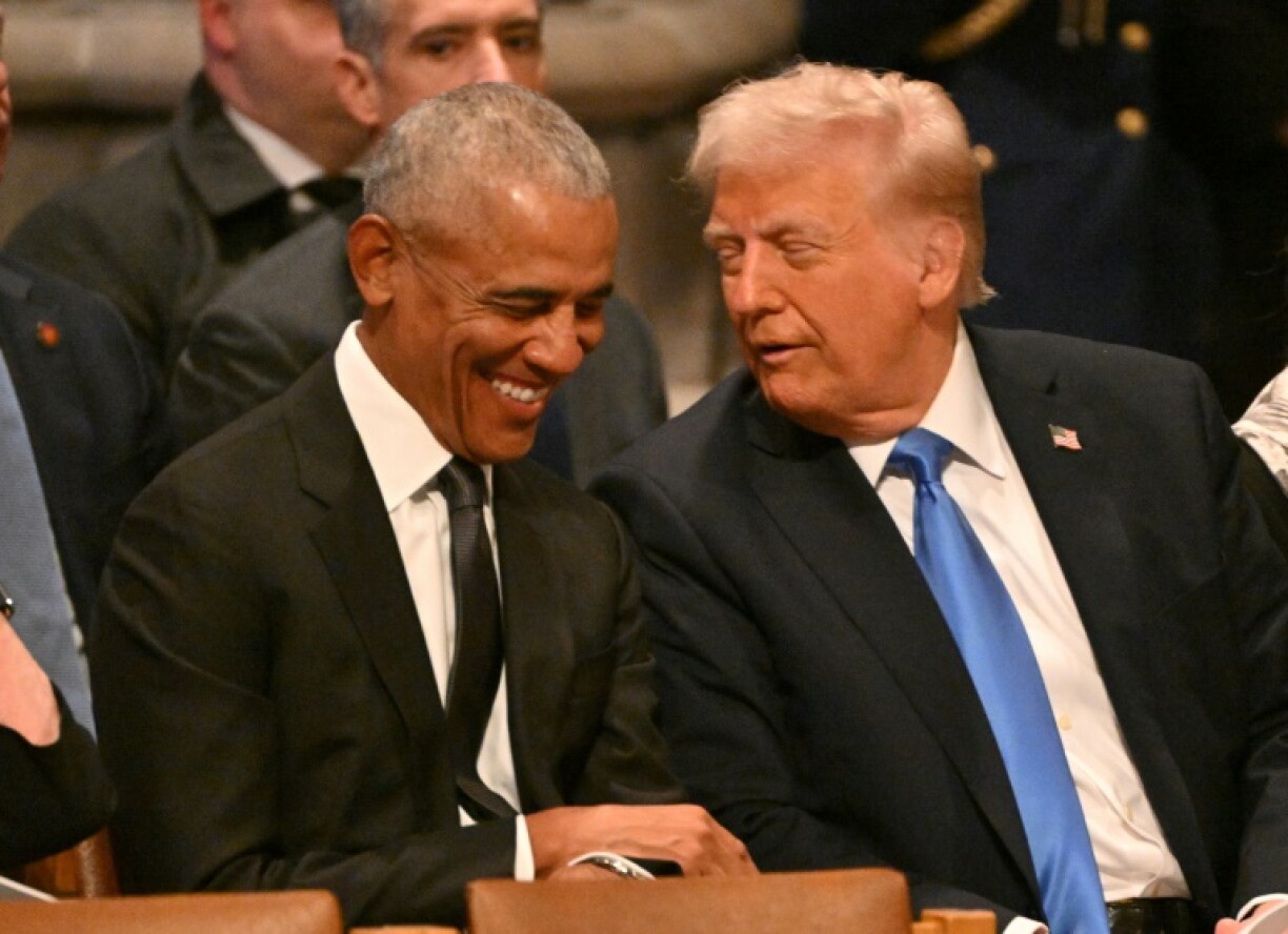 Former US president Barack Obama speaks with President-elect Donald Trump before Jimmy Carter's funeral