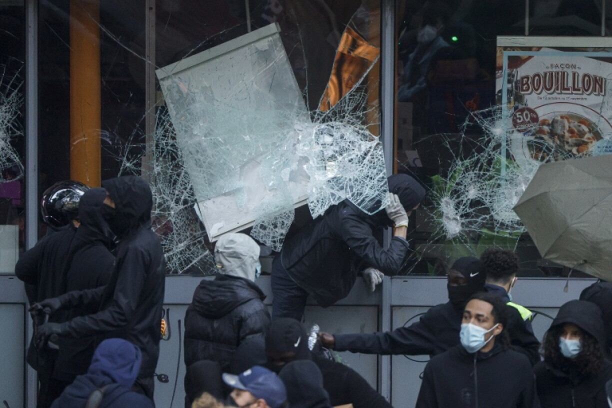 Crowds of masked men wearing black roamed the streets, breaking shop windows and clearing shelves