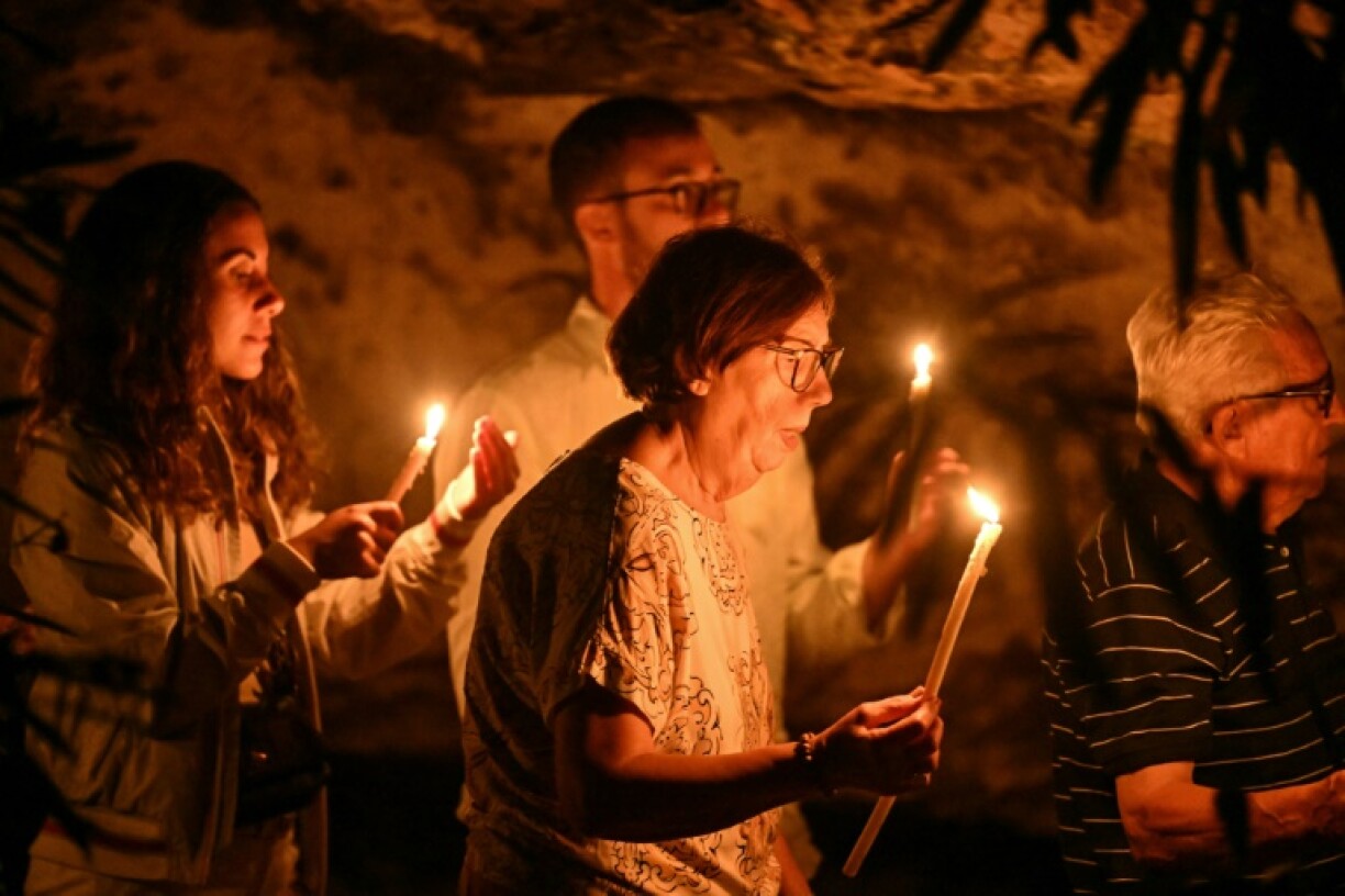 Islanders held a vigil in memory of the dead at a local Catholic shrine