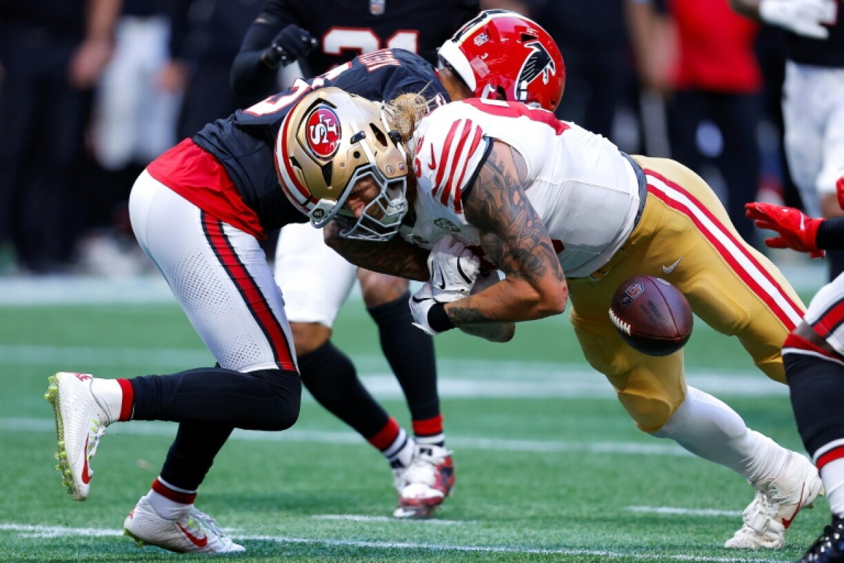 Jessie Bates III of the Atlanta Falcons punches the ball out from George Kittle in the Falcons' NFL victory over the San Francisco 49ers