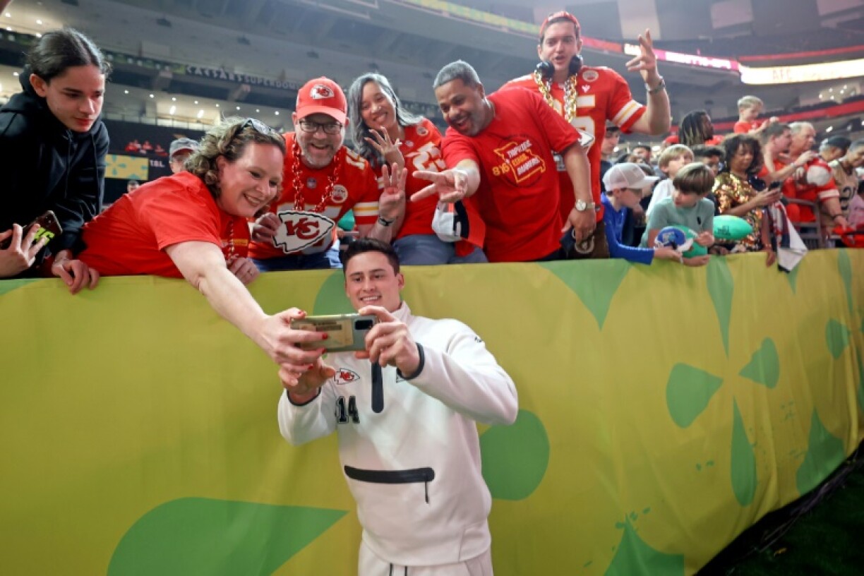 Kansas City Chiefs punter Matt Araiza takes a selfie with Chiefs fans inside the Superdome during the Super Bowl Opening Night on Monday.