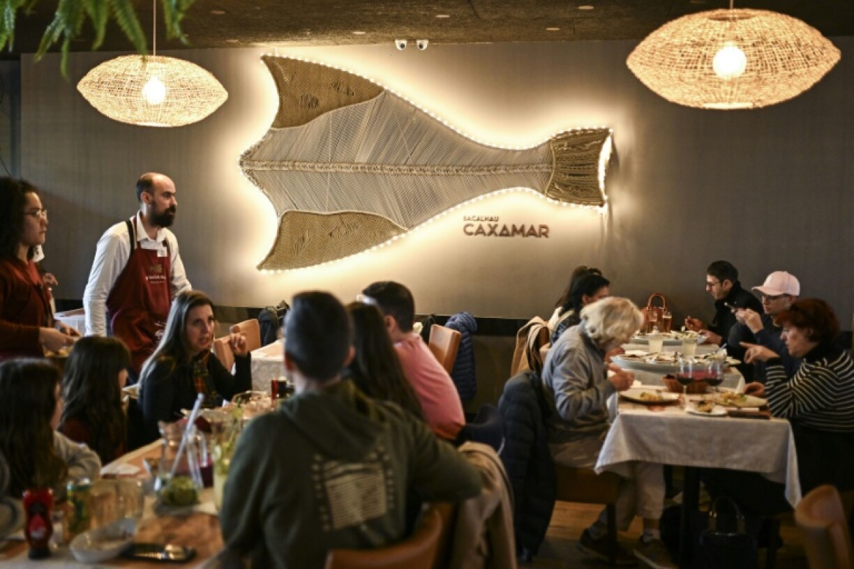 Customers enjoy a meal at a Lisbon restaurant specialized in traditional cod-based recipes, D’Bacalhau, where they cook a minimum of eight tons of cod per month