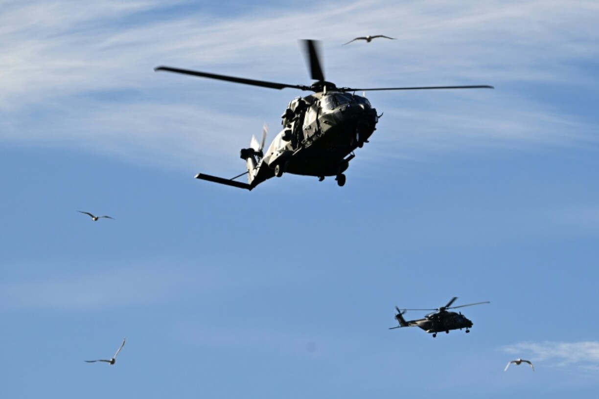 Two NH90 transport helicopters of the Bundeswehr patrol at Hamburg harbor during Red Storm Bravo