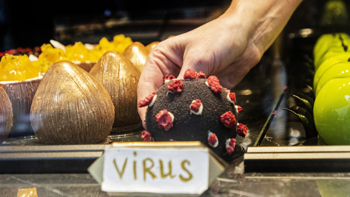 A waitress takes a dessert in shape of the covid-19 coronavirus in a cafe on October 06, 2020 in Prague. With more than 81,000 cases in the Czech Republic, the rate of the virus’s spread is among the worst in Europe – almost as severe as in Spain.