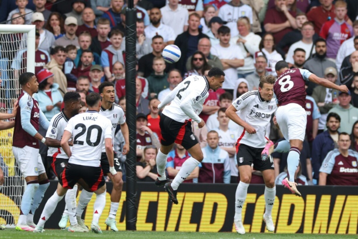 Aston Villa's Youri Tielemans (R) heads the winner against Fulham